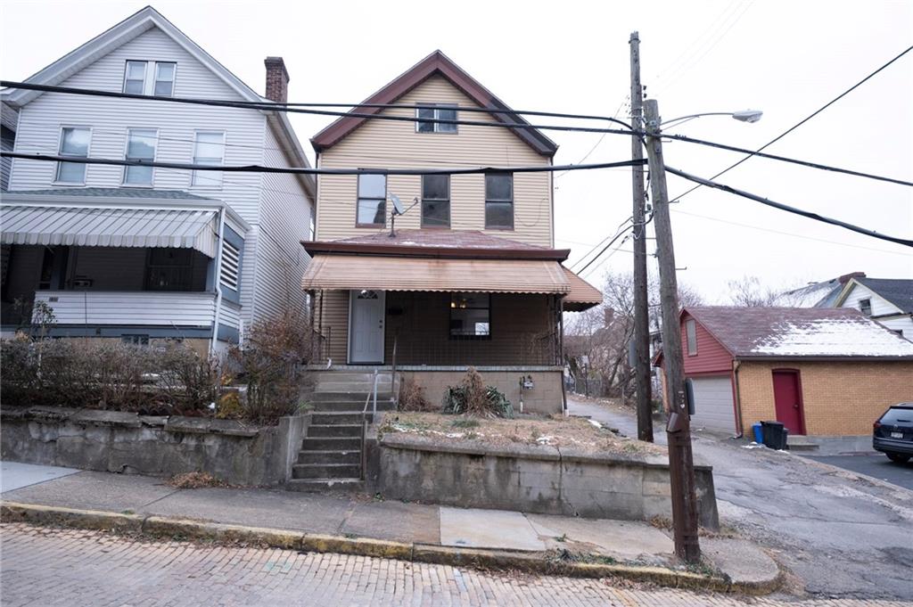 108 Margaret Street McKees Rocks, PA 15136 - Photo 2 of 29 a front view of a house with a fireplace and a fire pit