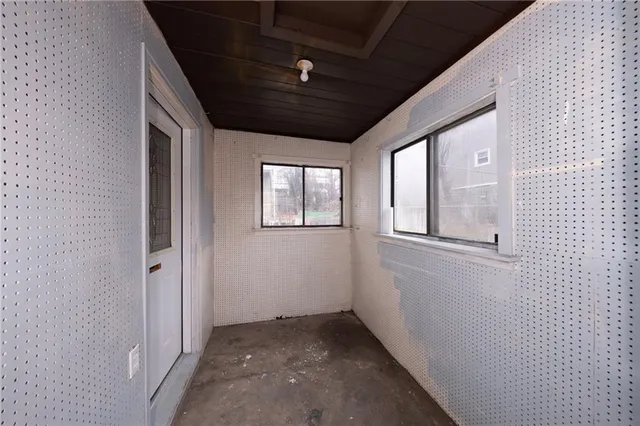 a view of a white house with large windows