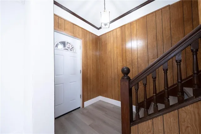 a view of a hallway with wooden floor and staircase