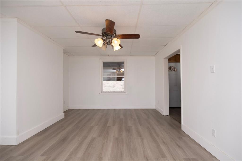 108 Margaret Street McKees Rocks, PA 15136 - Photo 6 of 29 a view of a room with wooden floor ceiling fan and window