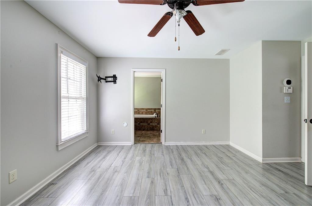 561 Holland Road Dallas, GA 30157 - Photo 25 of 48 an empty room with wooden floor cabinet and windows