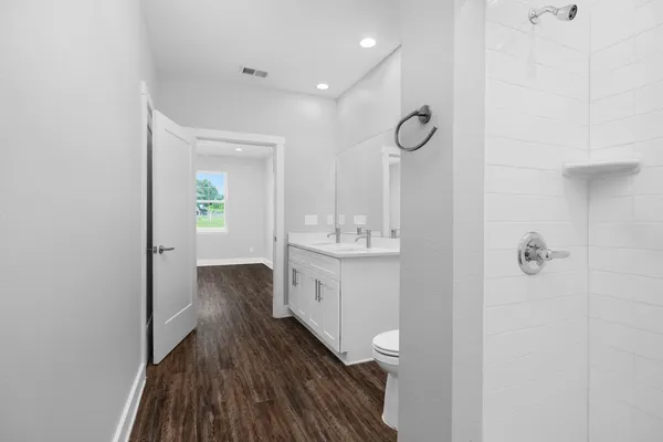 a spacious bathroom with a double vanity sink and a mirror