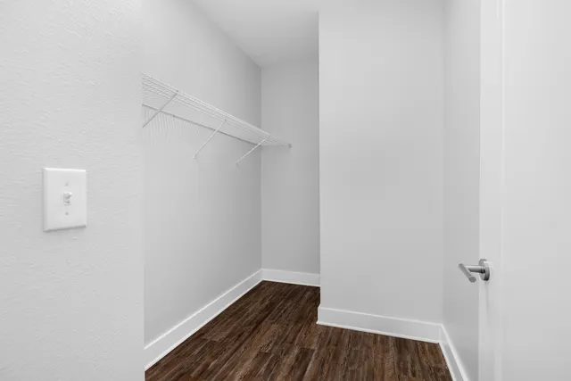 a view of a room with wooden floor