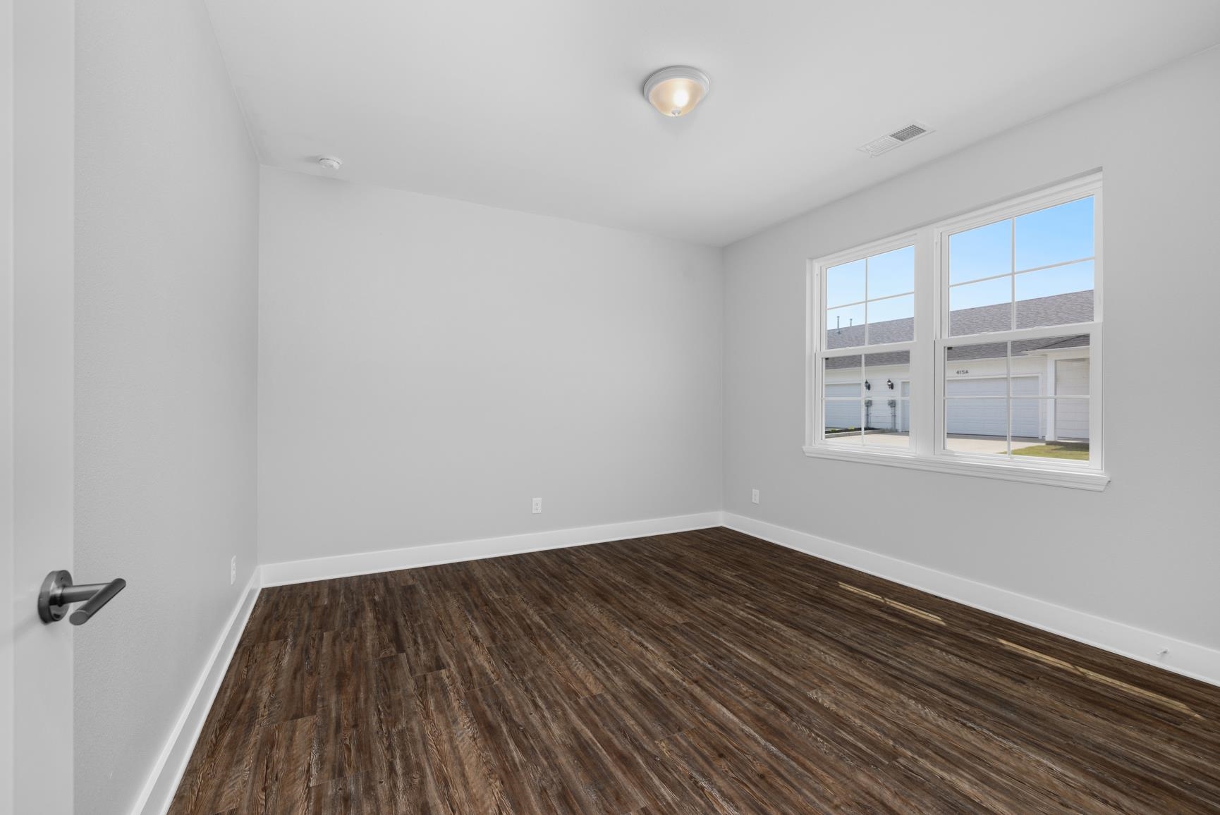 447 Abbey Road, Unit D Munford, TN 38058 - Photo 17 of 20 wooden floor in an empty room with a window