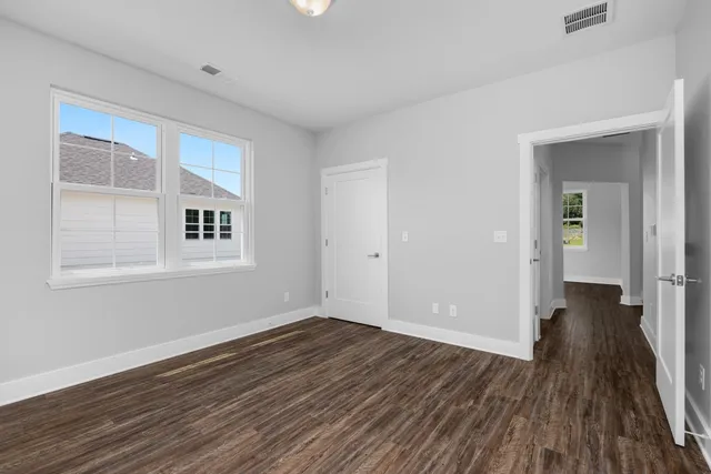 a view of a room with wooden floor and windows