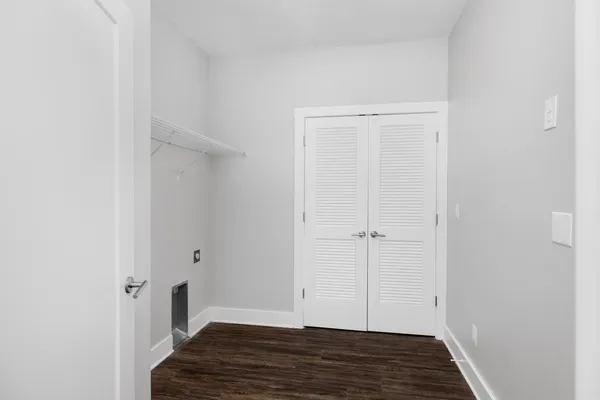 a view of a room with wooden floor
