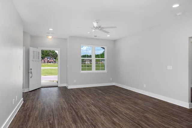 wooden floor in an empty room with a window