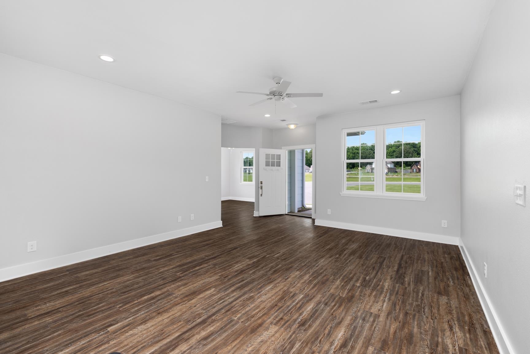 447 Abbey Road, Unit D Munford, TN 38058 - Photo 5 of 20 an empty room with wooden floor and windows