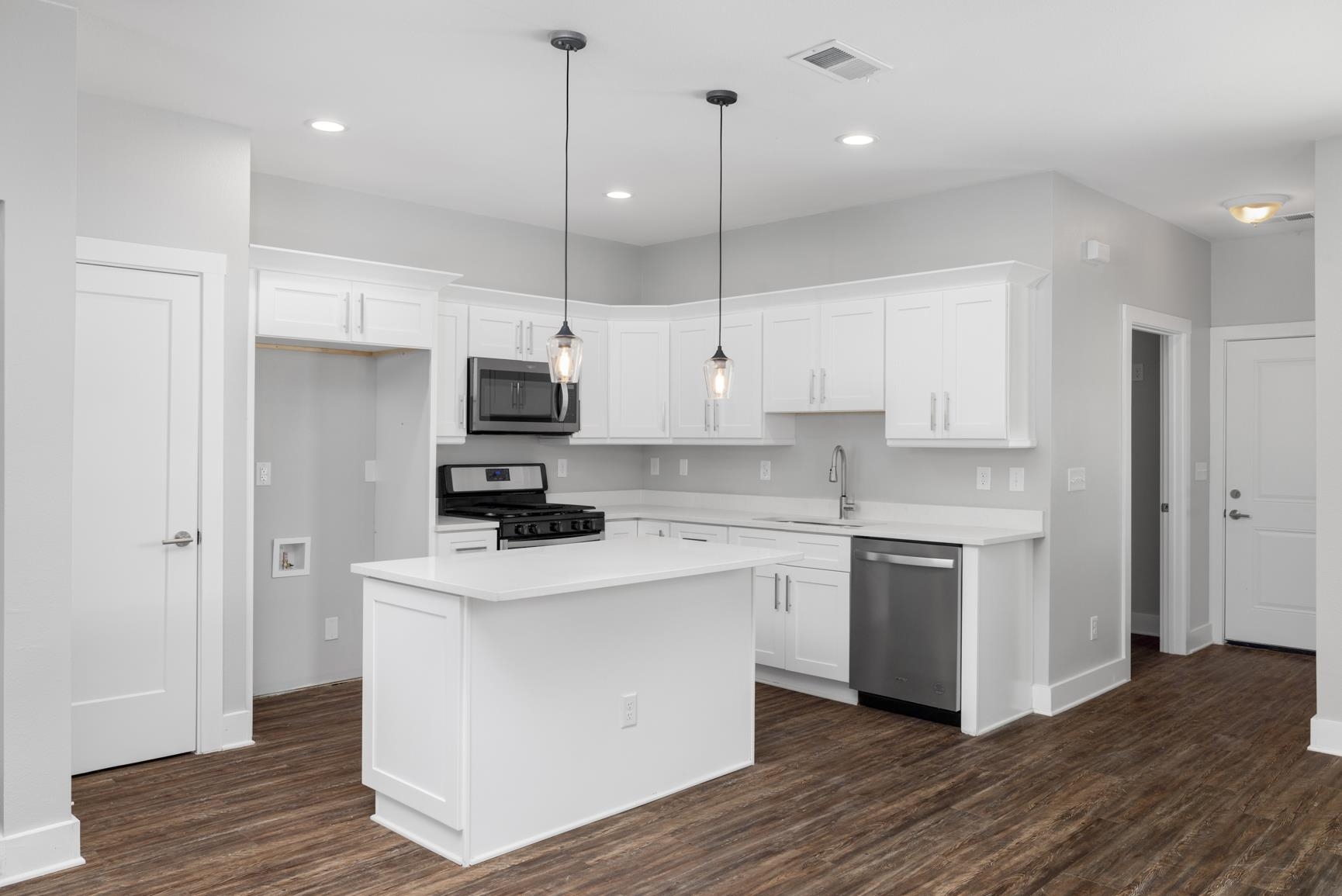 447 Abbey Road, Unit D Munford, TN 38058 - Photo 7 of 20 a kitchen with stainless steel appliances granite countertop a stove a sink and a refrigerator