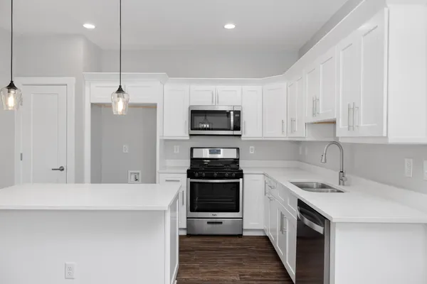 a kitchen with a sink a stove and oven