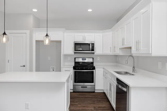 a kitchen with a sink a stove and oven