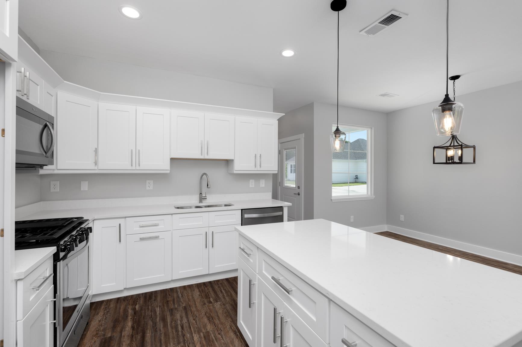 447 Abbey Road, Unit D Munford, TN 38058 - Photo 9 of 20 a kitchen with a sink a stove a refrigerator and white cabinets