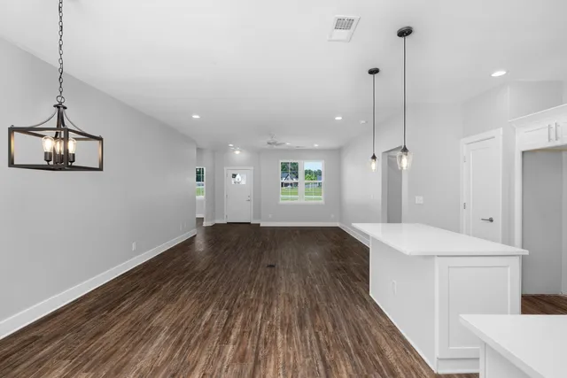 a view of a kitchen and wooden floor