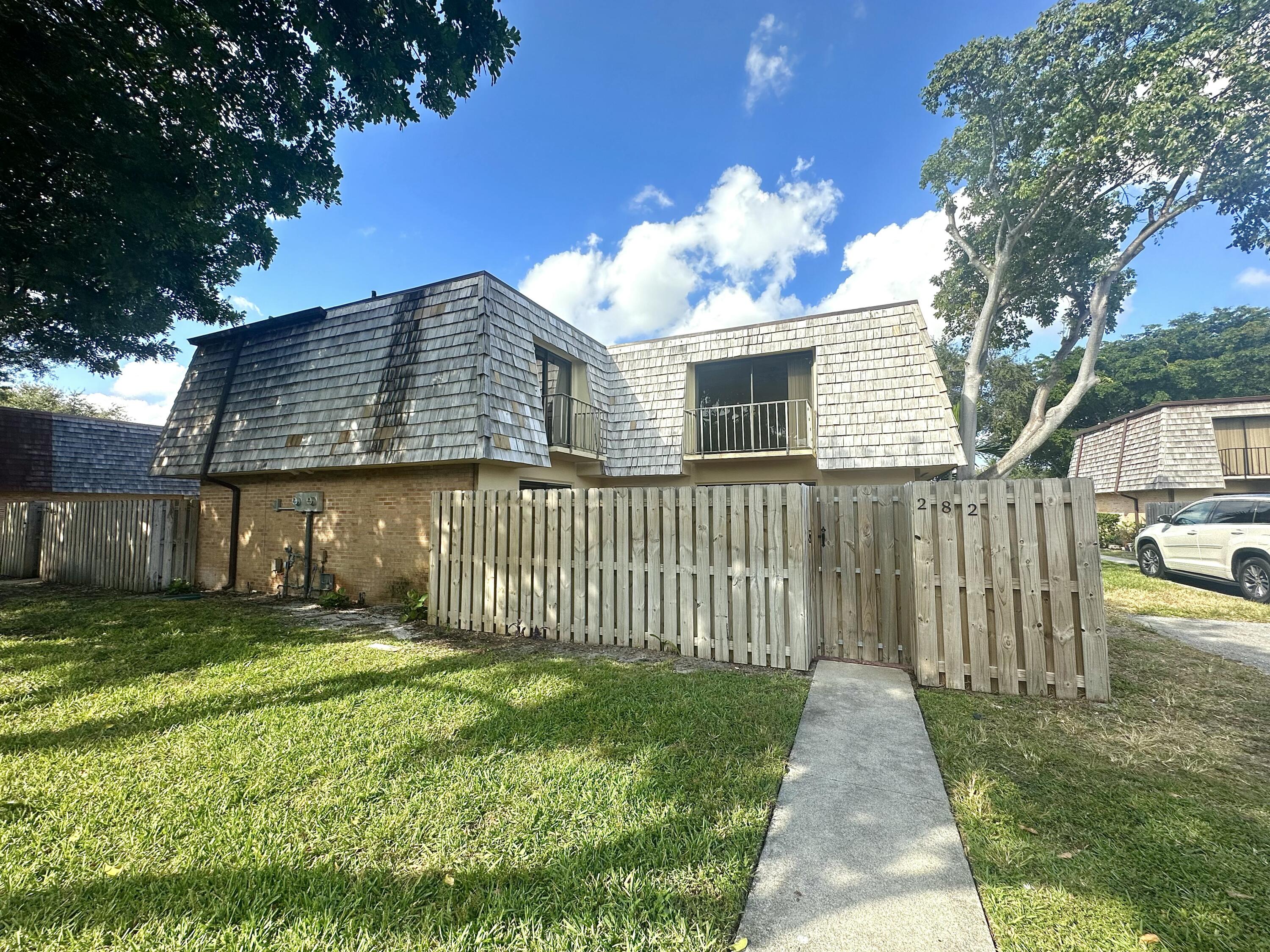 282 Arabian Road Palm Springs, FL 33461 - Photo 1 of 26 a front view of a house with a yard