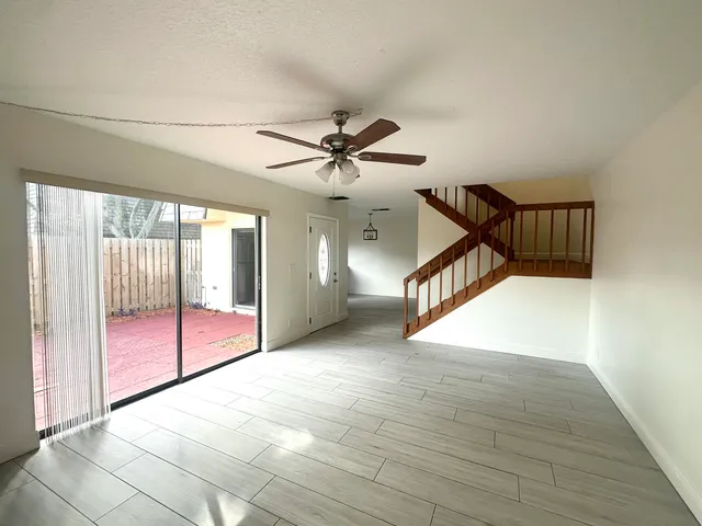 wooden floor in a room with a ceiling fan