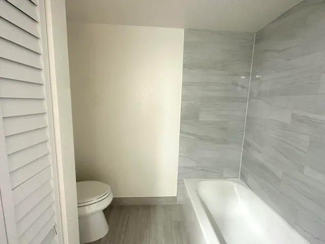 a bathroom with a toilet and a shower