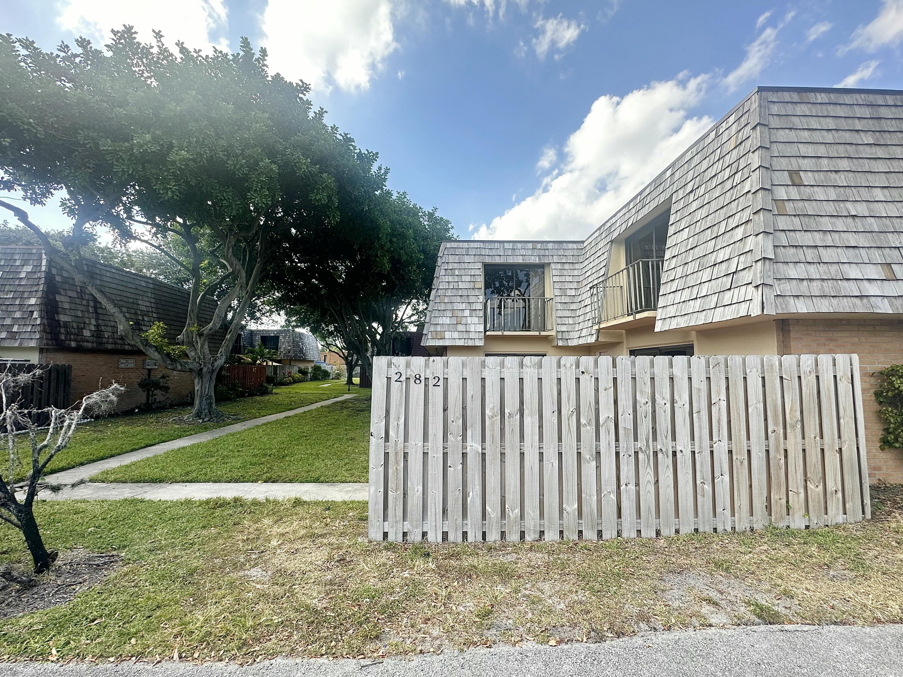 282 Arabian Road Palm Springs, FL 33461 - Photo 26 of 26 a front view of a house with a garden