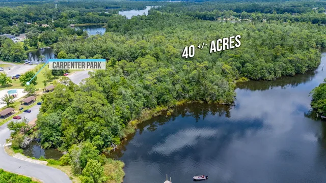 an aerial view of a house with outdoor space and lake view