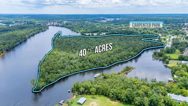 an aerial view of a house with a lake view