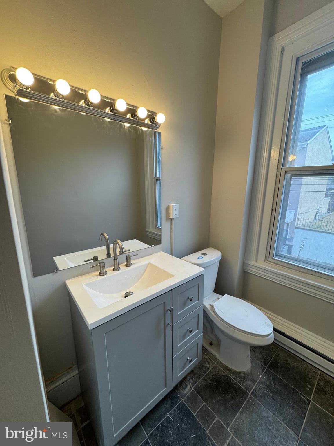 521 Cherry Street, Unit 3 Norristown, PA 19401 - Photo 5 of 7 a bathroom with a toilet a sink and mirror