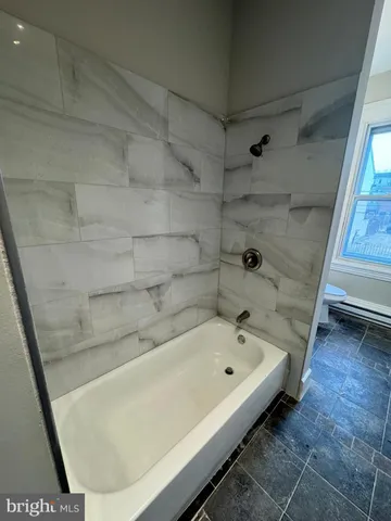 a bathroom with a bathtub and shower