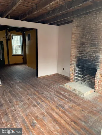 a view of a livingroom with wooden floor and a window