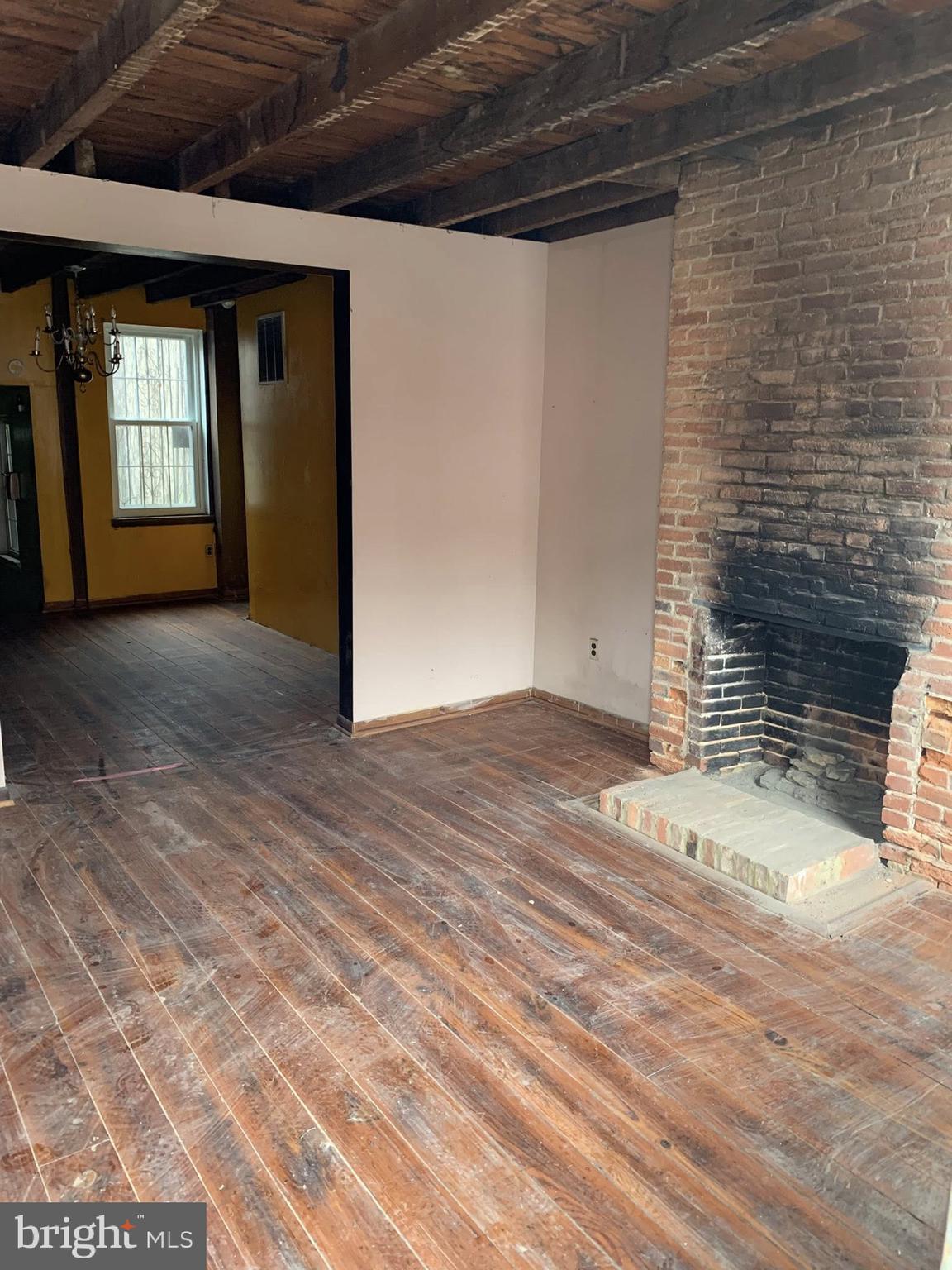 642 Portland Street Baltimore, MD 21230 - Photo 11 of 17 a view of a livingroom with wooden floor and a window