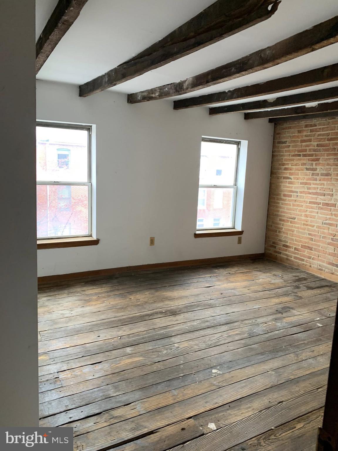 642 Portland Street Baltimore, MD 21230 - Photo 7 of 17 a view of an empty room with wooden floor and a window