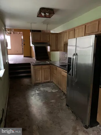 a kitchen with a refrigerator and a sink
