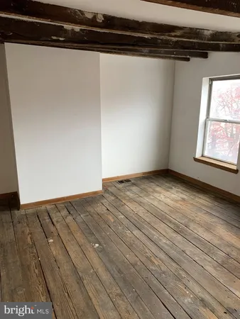 a view of a room with wooden floor and fan