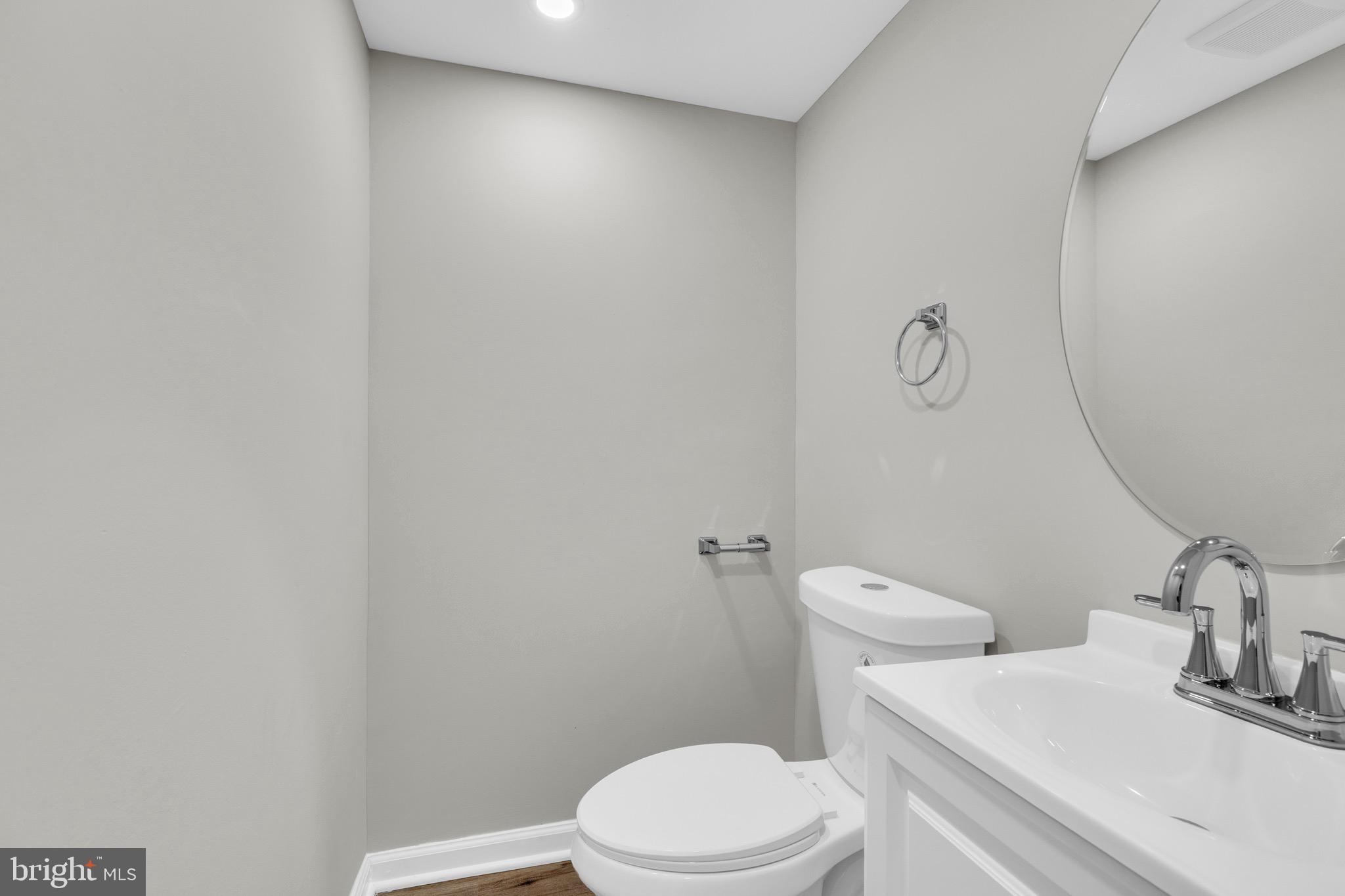 8677 Hickory Ridge Court Springfield, VA 22153 - Photo 12 of 31 a white toilet sitting next to a bathroom sink