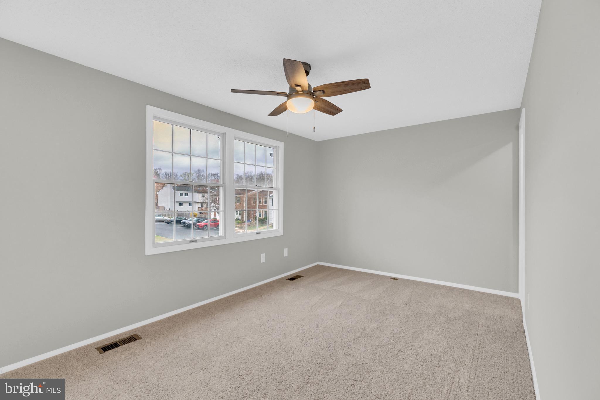 8677 Hickory Ridge Court Springfield, VA 22153 - Photo 14 of 31 an empty room with windows and fan