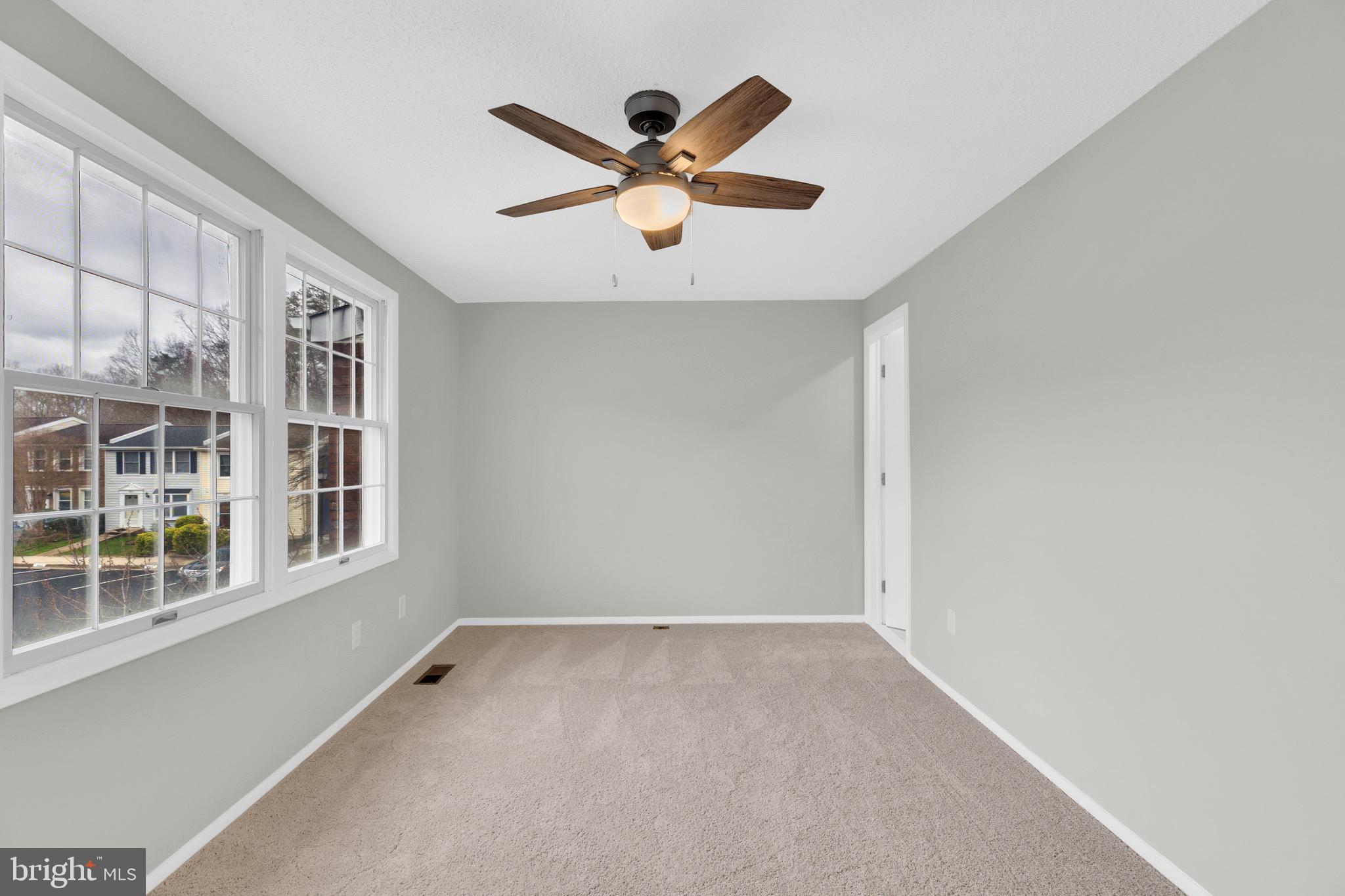 8677 Hickory Ridge Court Springfield, VA 22153 - Photo 17 of 31 an empty room with ceiling fan and window