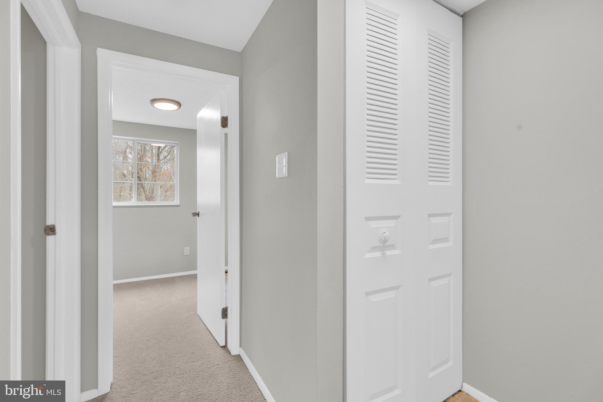 8677 Hickory Ridge Court Springfield, VA 22153 - Photo 18 of 31 a view of a hallway with windows and a bathroom