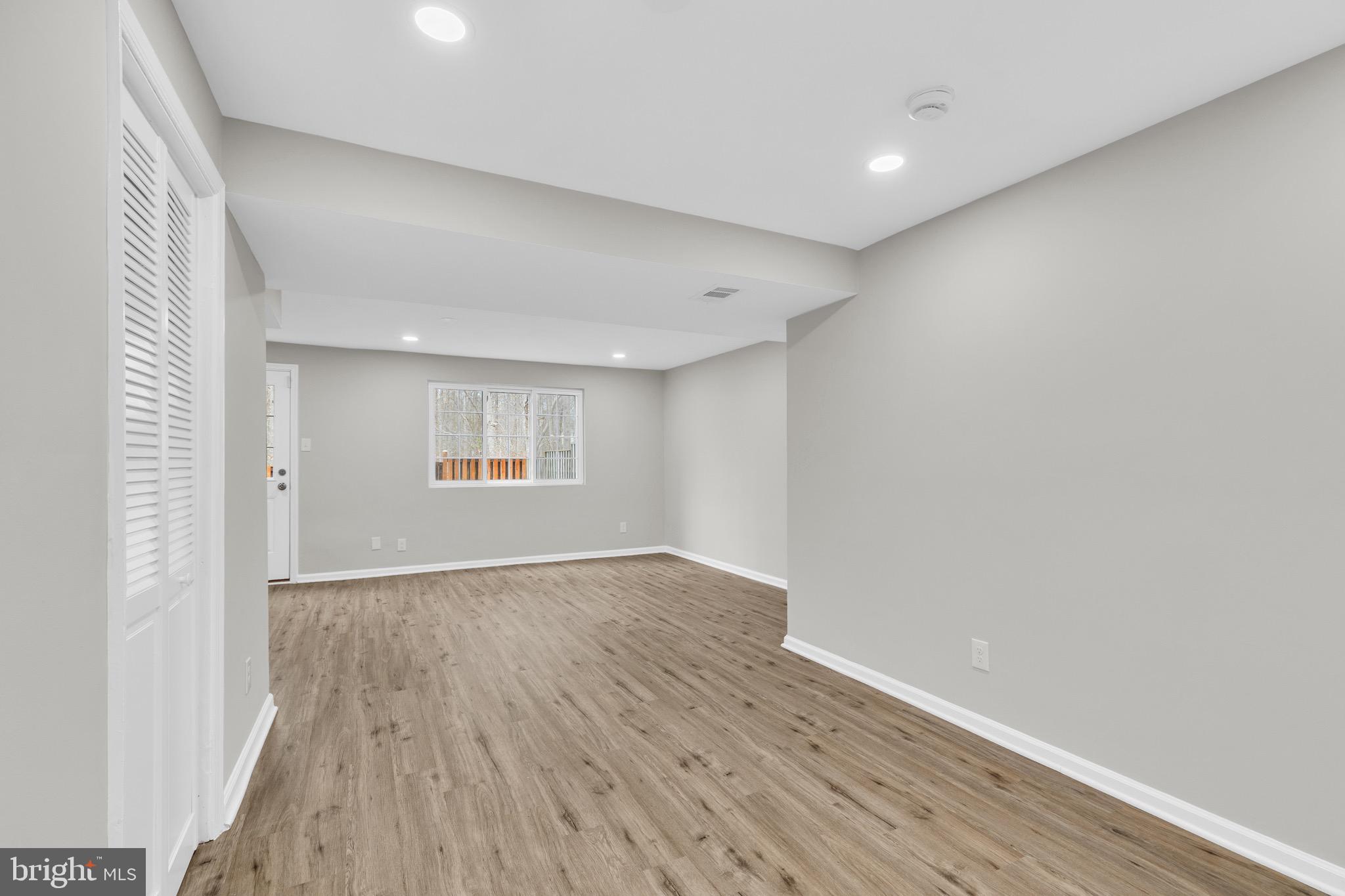 8677 Hickory Ridge Court Springfield, VA 22153 - Photo 24 of 31 an empty room with wooden floor and windows