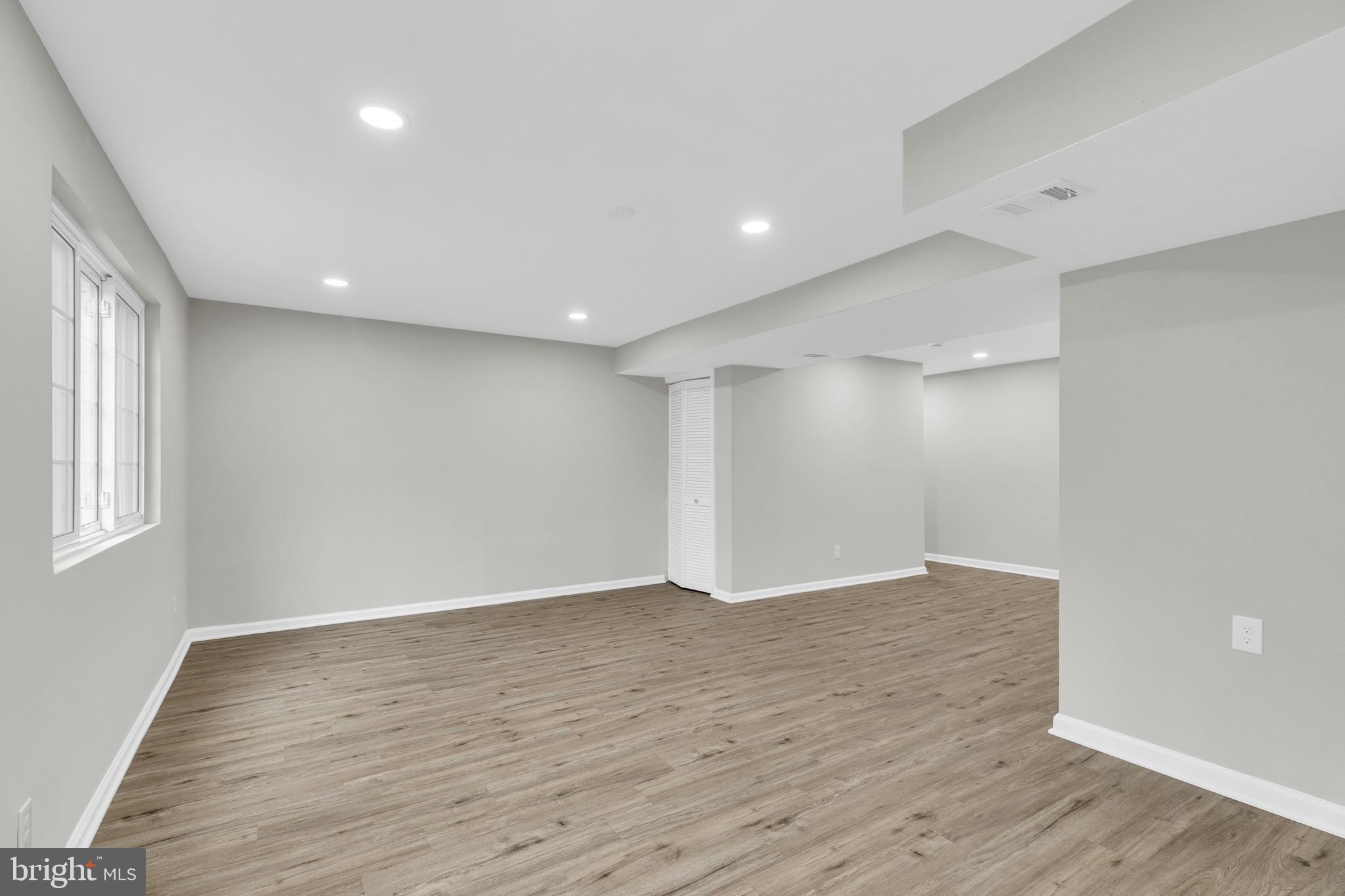 8677 Hickory Ridge Court Springfield, VA 22153 - Photo 26 of 31 a view of an empty room with wooden floor and a window