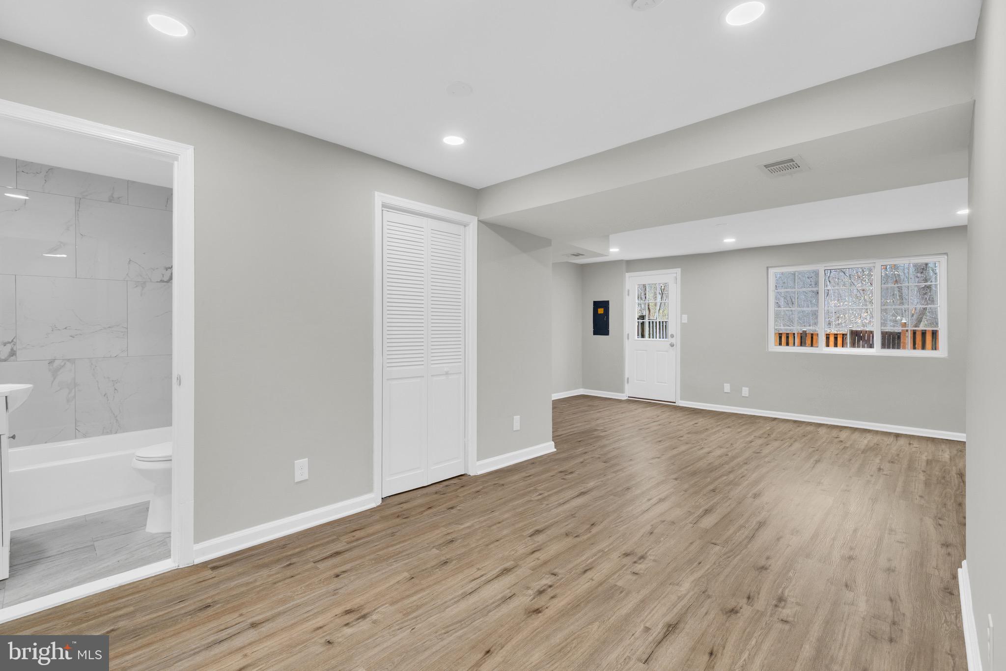 8677 Hickory Ridge Court Springfield, VA 22153 - Photo 27 of 31 a view of an empty room with wooden floor and a window