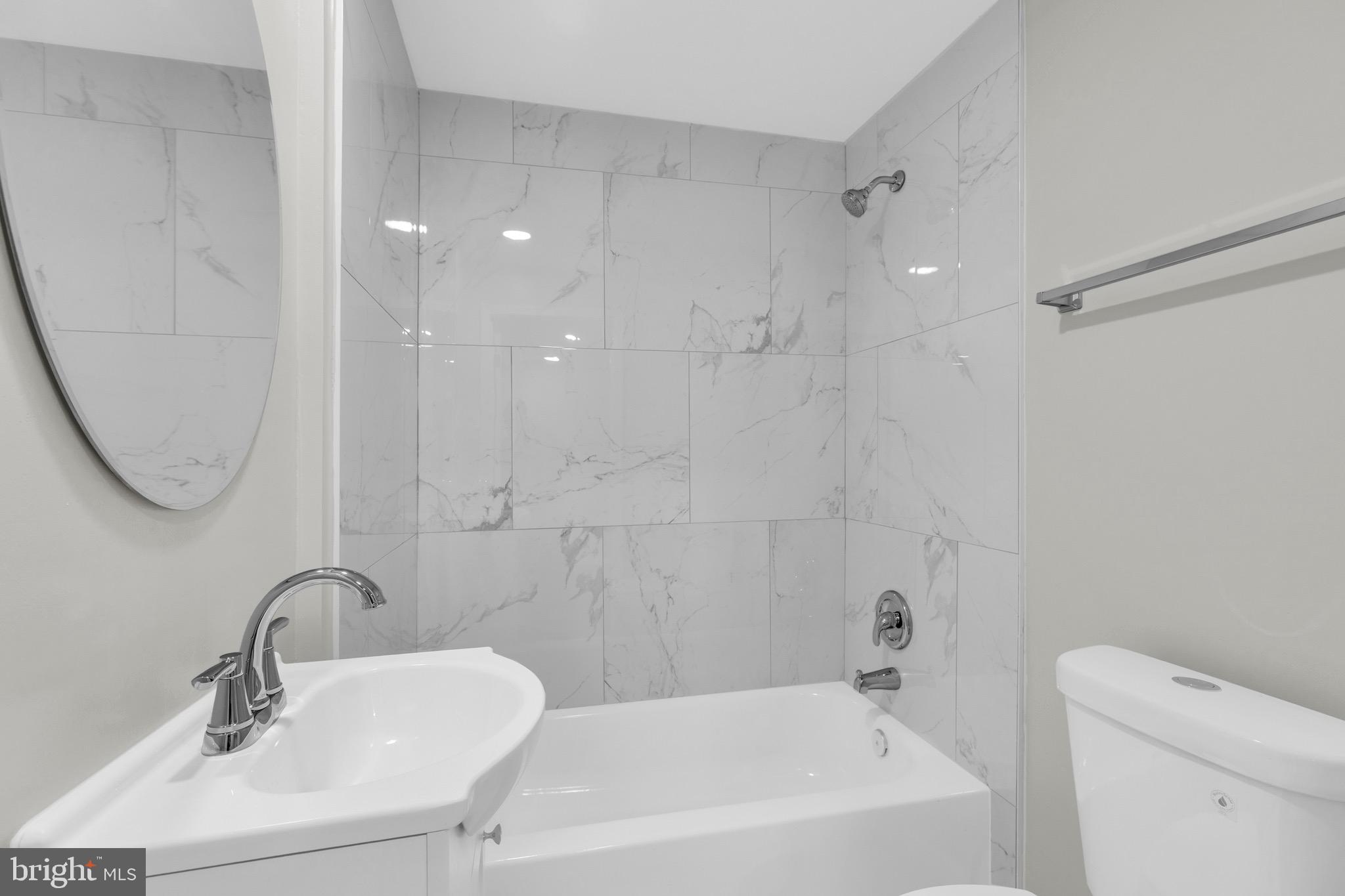 8677 Hickory Ridge Court Springfield, VA 22153 - Photo 28 of 31 a bathroom with a sink a toilet and a bathtub