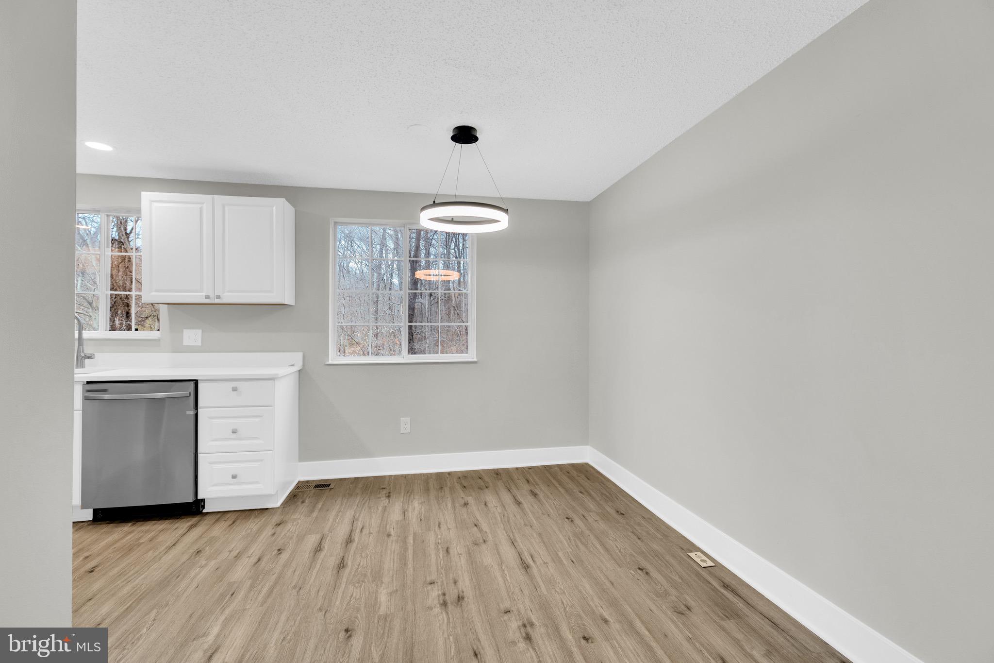 8677 Hickory Ridge Court Springfield, VA 22153 - Photo 7 of 31 a view of a kitchen with wooden floor and a sink