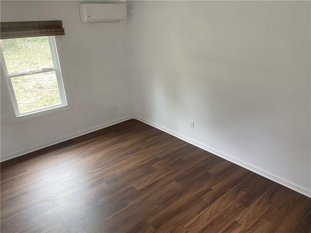 348 Hortman Avenue Macon, GA 31204 - Photo 14 of 18 an empty room with wooden floor and windows