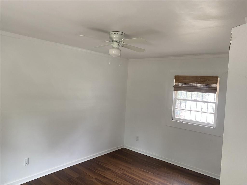 348 Hortman Avenue Macon, GA 31204 - Photo 6 of 18 an empty room with wooden floor and windows