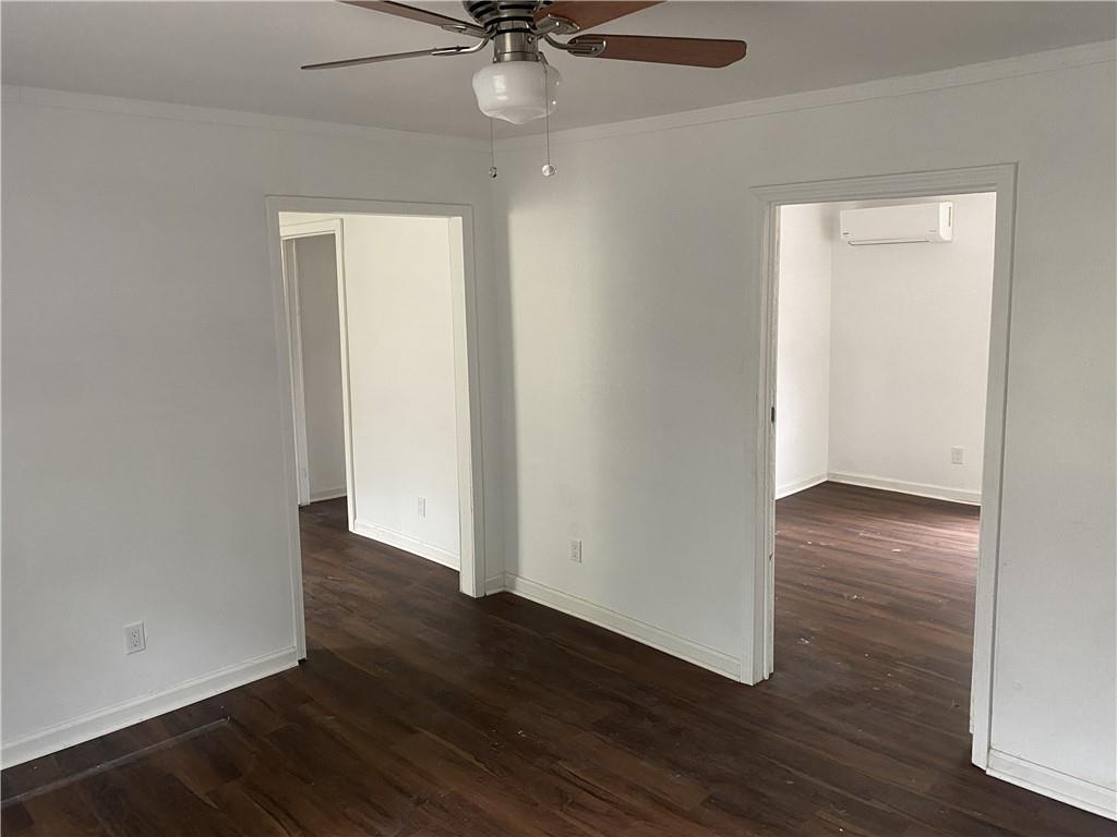 348 Hortman Avenue Macon, GA 31204 - Photo 10 of 18 an empty room with wooden floor a ceiling fan and closet