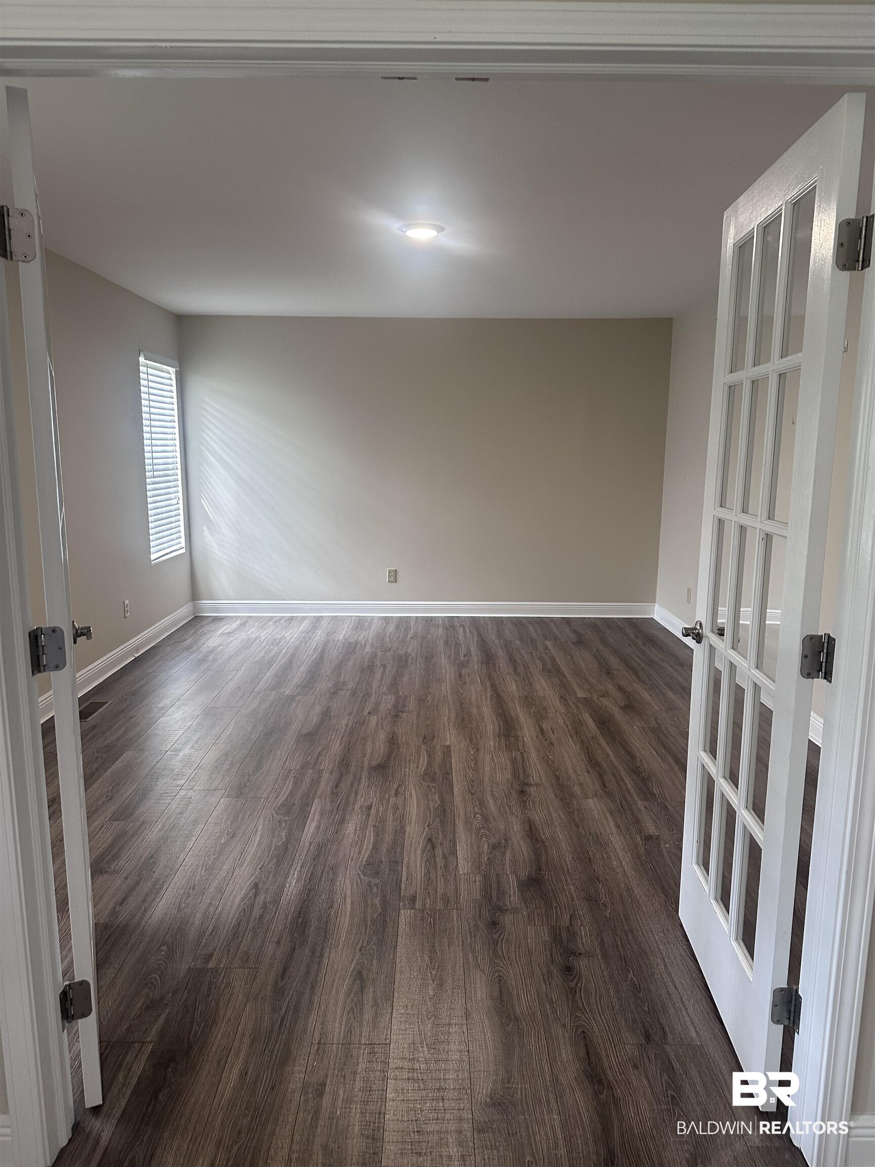 2785 Sowell Road Brewton, AL 36426 - Photo 3 of 24 Empty room with dark wood-style floors and baseboards