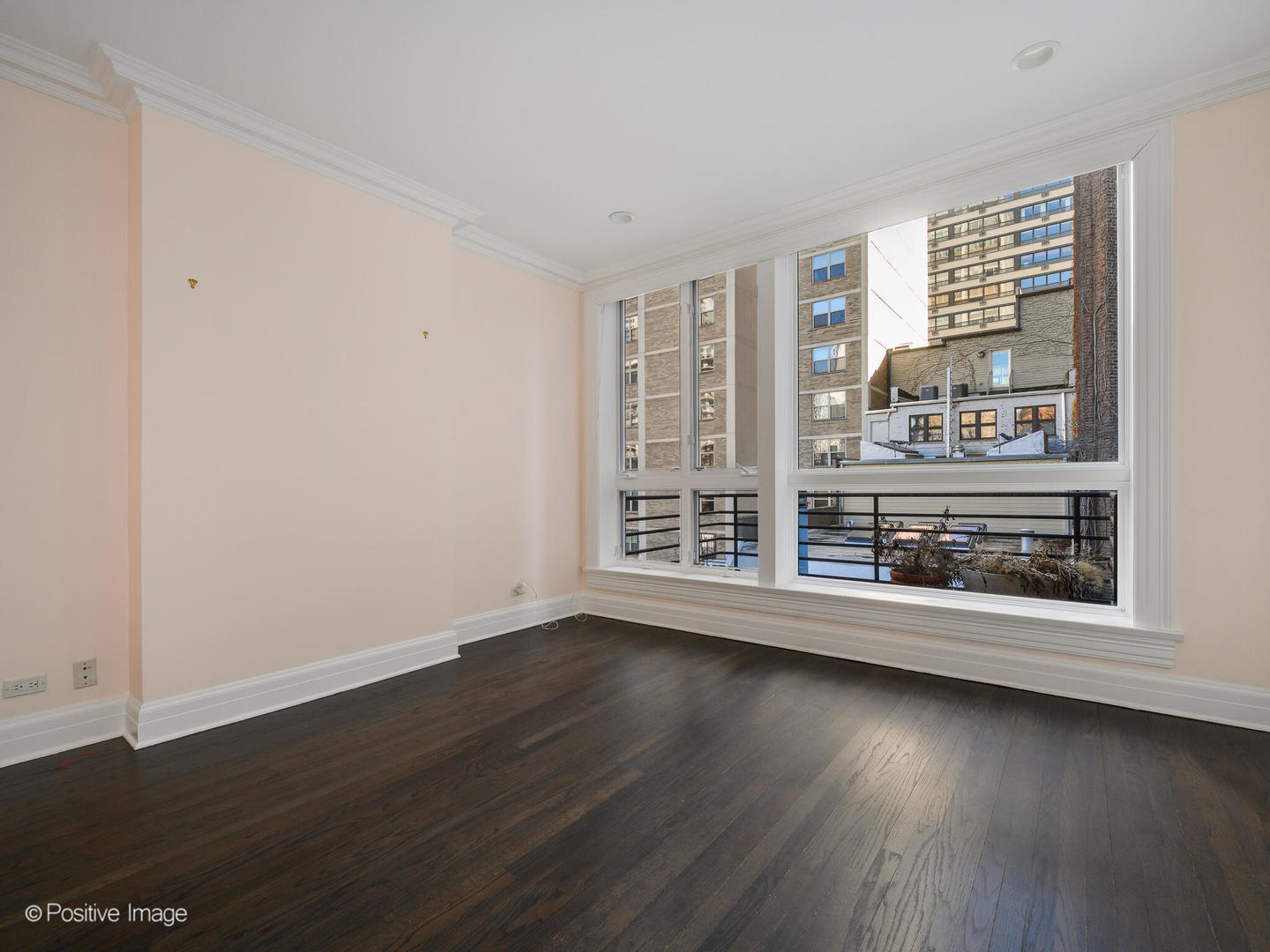 37 East Elm Street Chicago, IL 60611 - Photo 24 of 32 a view of an empty room with wooden floor and a window