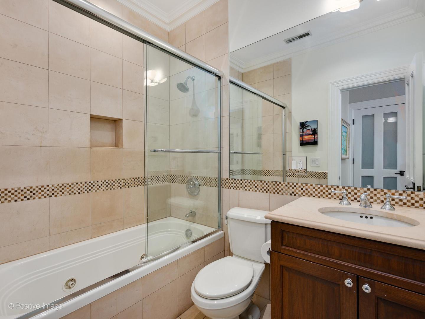 37 East Elm Street Chicago, IL 60611 - Photo 25 of 32 a bathroom with a sink toilet vanity and shower