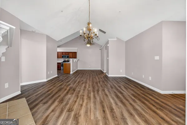 a view of a room with wooden floor and ceiling fan