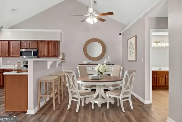 a view of a dining room with furniture and wooden floor