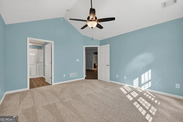 a view of a room with a ceiling fan