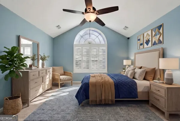 a spacious bedroom with bed and a chandelier