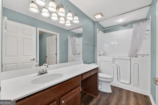 a bathroom with a double vanity sink mirror and toilet
